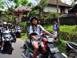 Children driving motorbikes in Bali