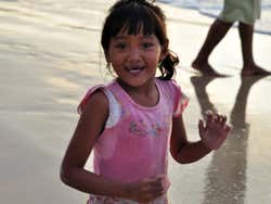 Young girl playing on Jimbaran Beach