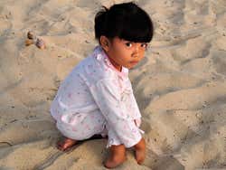 Young girl playing on Jimbaran Beach