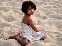 Young girl playing on Jimbaran Beach